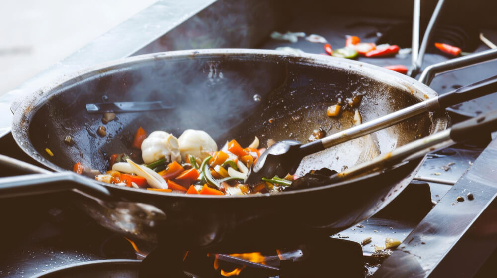 Cum se folosește un wok pentru a păstra aromele asiatice?